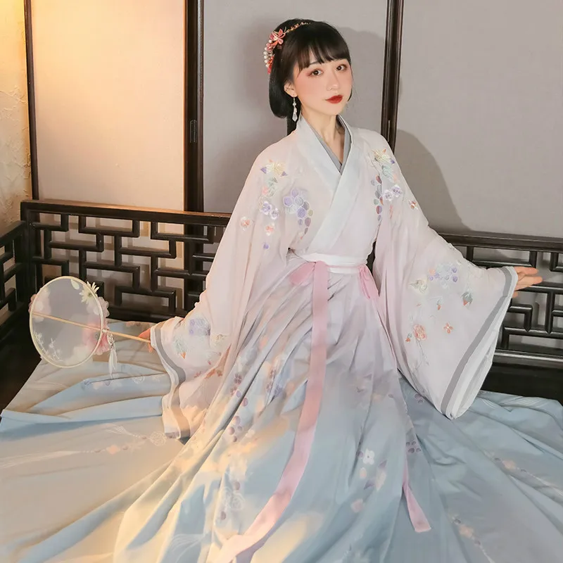 Elegant Hanfu ensemble with flowing sleeves and traditional cross-collar design