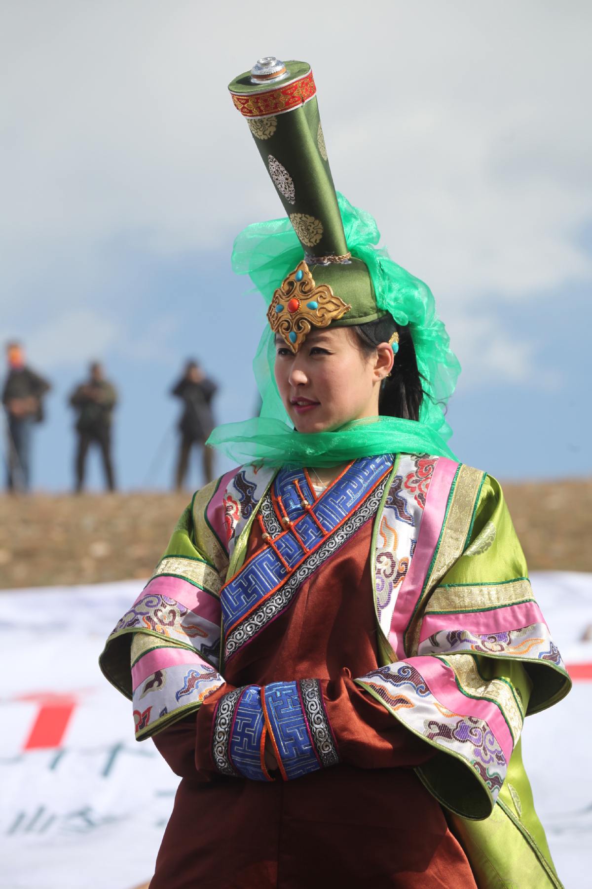 A Mongol herder in a traditional deel robe standing on the vast Inner Mongolian grassland at dawn