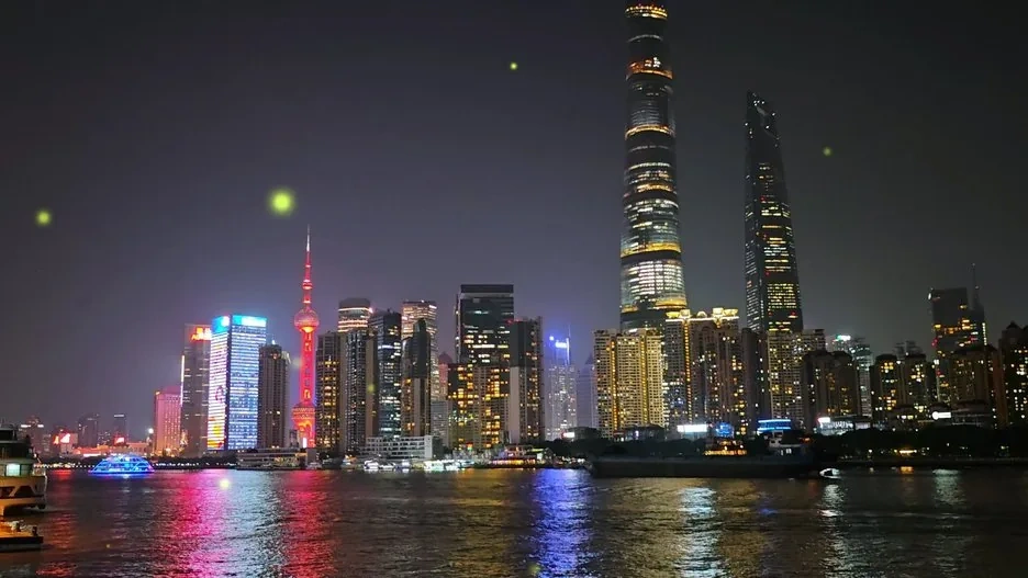 The Shanghai Bund at night with the illuminated Pudong skyline reflected in the Huangpu River