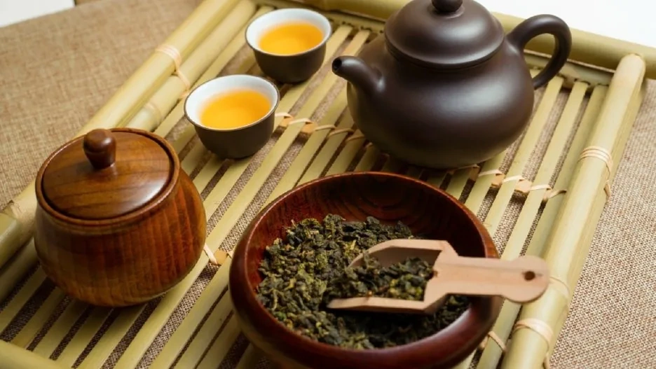 A traditional Chinese tea ceremony with a master pouring tea in a serene setting
