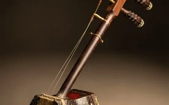 A two-stringed erhu fiddle with a small resonating body
