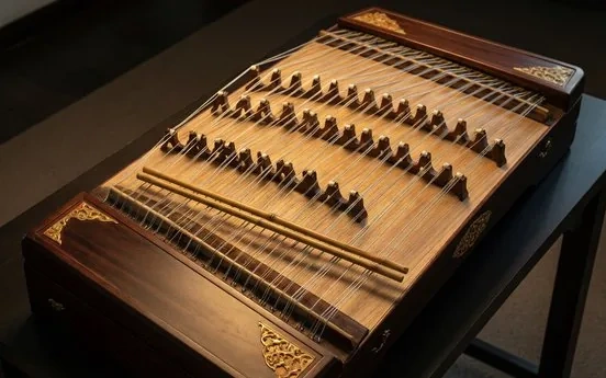 A trapezoidal yangqin hammered dulcimer with bamboo hammers