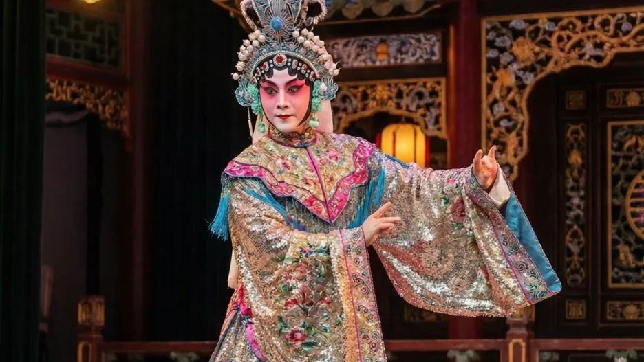 A Cantonese opera performer in an elaborate sequined costume and ornate headdress, the glittering splendor of southern Chinese theater on full display