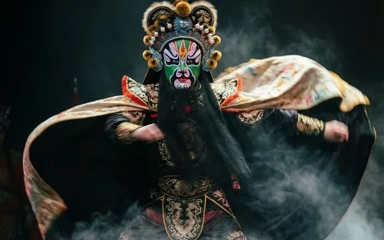 A Sichuan Opera performer mid face-change