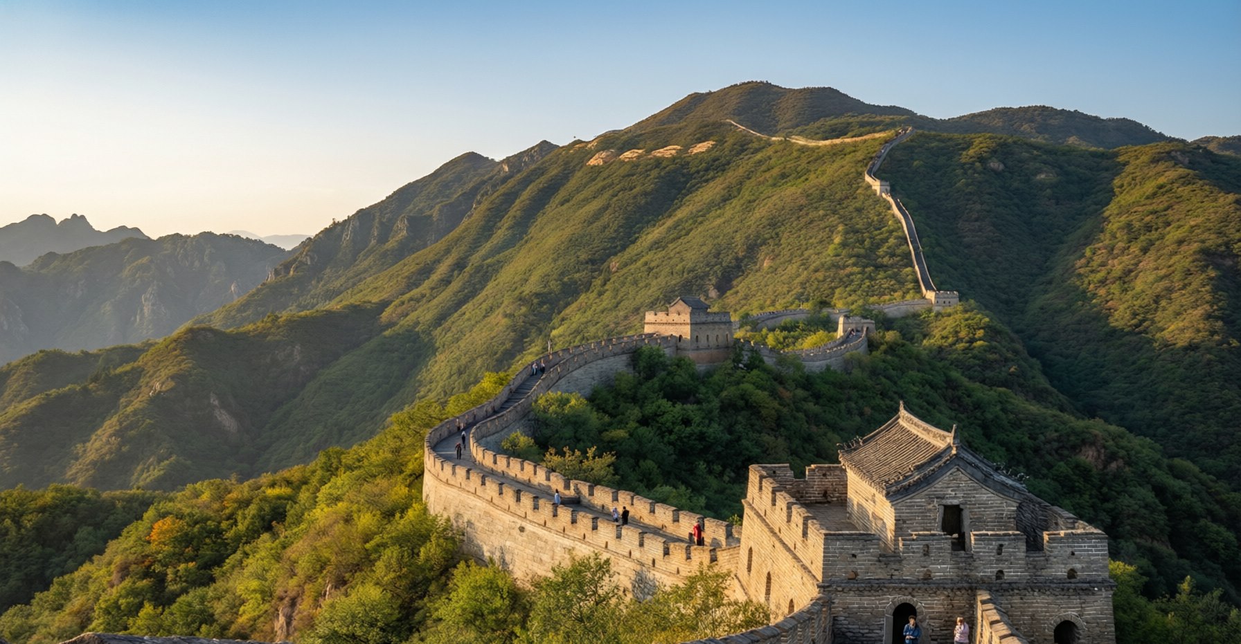 The Great Wall winding over green mountains in pleasant early-autumn golden-hour light with a few travelers